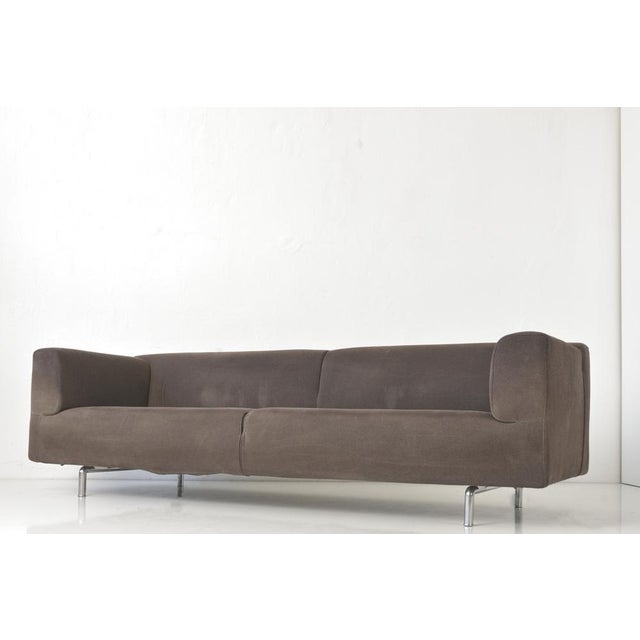 The two linear MET 250 sofas by Piero Lissoni are covered in a cosily warm, dark brown pile fabric cover. The large size,...