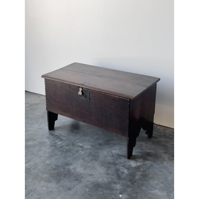 A rare antique 17th century English oak plank coffer with a deep, dark patina. Lift lid with iron hinges and original iron...