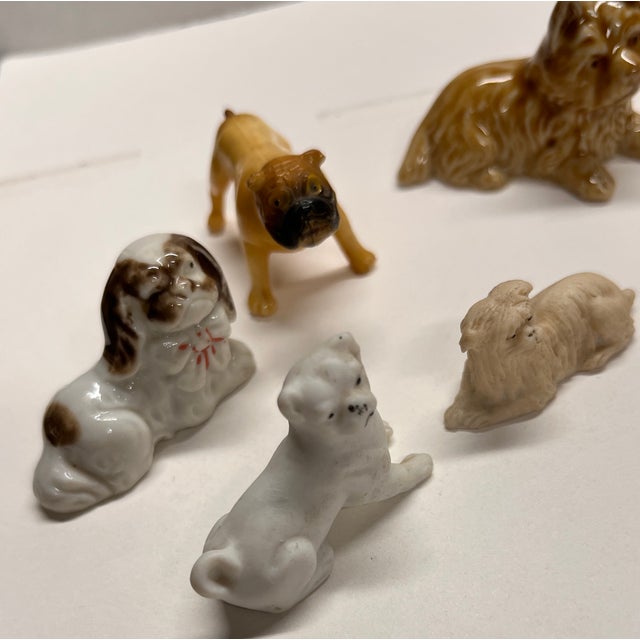 A wonderful array of vintage miniature ceramic dogs for your collections: bulldog, terrier, boxer, and other small dog...