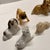 A wonderful array of vintage miniature ceramic dogs for your collections: bulldog, terrier, boxer, and other small dog...