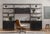 A mid-century-inspired design, black poplar and raw iron fuse for a forward-thinking two-piece bookcase with modular...