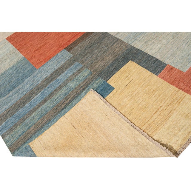 Beautiful modern Art Deco style hand-knotted wool rug with a beige, blue, brown, and orange field in a gorgeous all-over...
