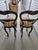 These are Victorian-style carved mahogany balloon-back swivel bar stools featuring multi-colored striped fabric upholstery...