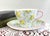 This vintage fine bone china teacup and saucer set was crafted by Shelley in Staffordshire, England. It features the...