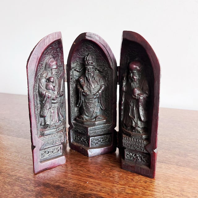 Antique Chinese triptych folding resin shrine, featuring intricate carvings of the three Sanxing gods, also known as the...