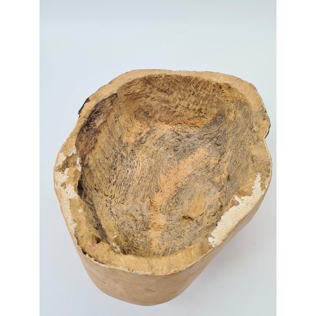 A striking, hand-carved wooden mask with a realistic, slightly theatrical facial expression. Made of light wood (most...