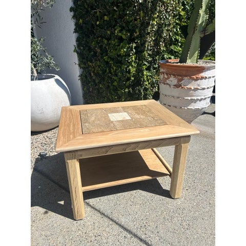 Vintage side table with square wood frame and inset stone top. Stone surface features a central contrasting tile detail...