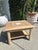 Vintage side table with square wood frame and inset stone top. Stone surface features a central contrasting tile detail...