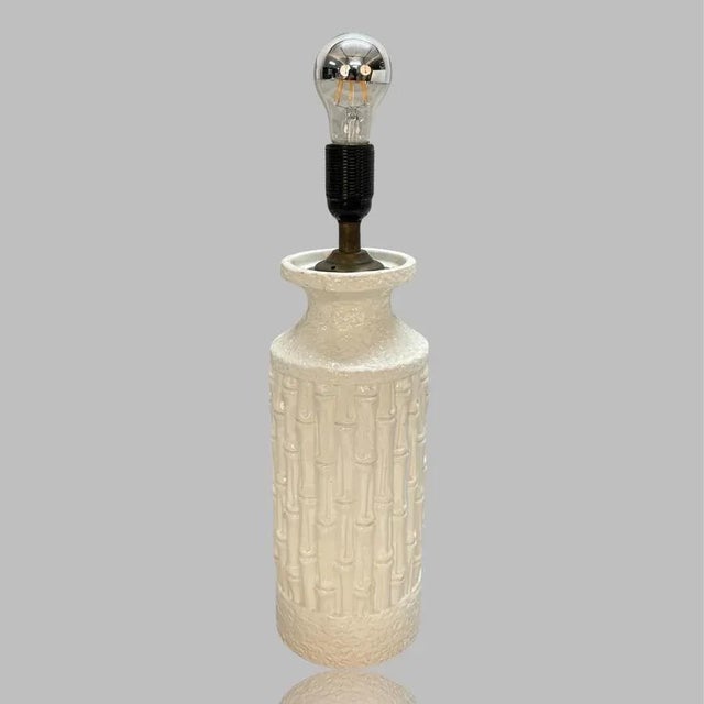 Iconic large Mid-Century white glazed ceramic lamp with bamboo effect. This fantastic piece was made in Italy during the...