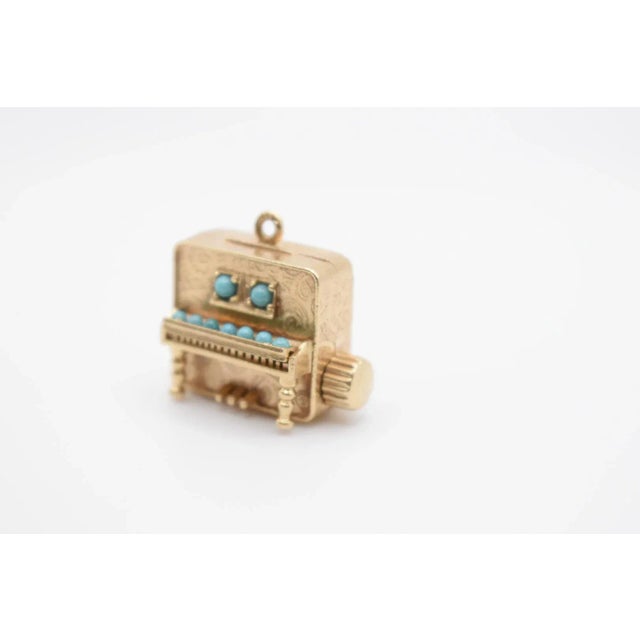This is an adorable Colibri piano charm perfect for a necklace or bracelet! It is gold and turquoise. It used to play a...