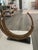 One gilted metal sculture mounted on a black marble base.. It is composed of a series of five open half circles connected...