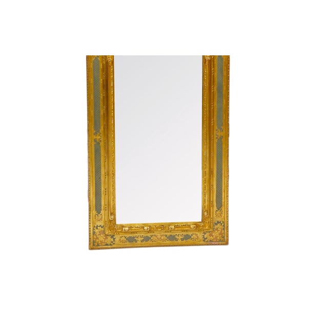 Mid-20th century Italian hanging wall mirror, executed in the Venetian style and featuring a richly carved, gessoed, and...