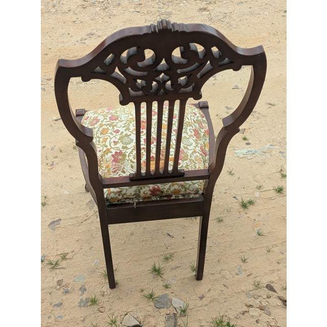 Chippendale style carved mahogany arm chair. This chair is sturdy and has a few imperfections. It needs new cloth on seat.