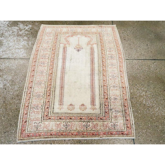 This mid-20th century Turkish Sivas rug, measuring 3' 2" x 4' 2", presents a refined prayer design rendered in a delicate...