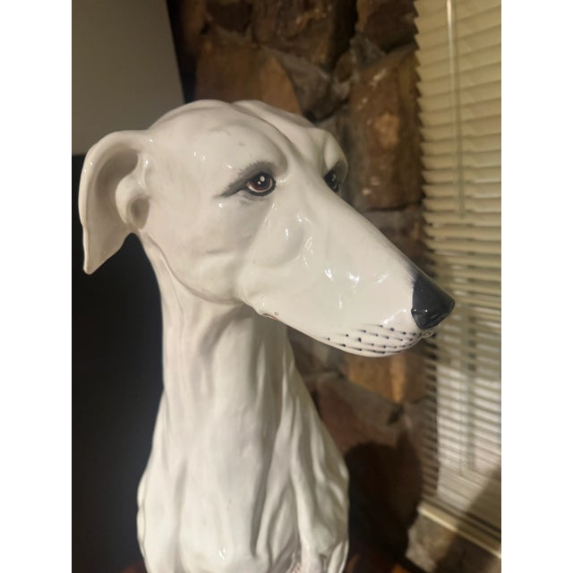 A life-size Italian ceramic greyhound sculpture. The sculpture is marked to the underside and dates from the 1960s-1970s....