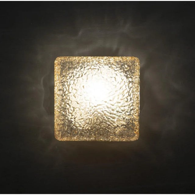 The shade is square, thick etched glass with a textured finish, the mount is brown metal. The glass creates a fantastic...