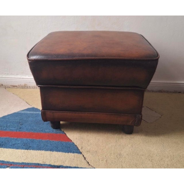 Vintage pouffe / ottoman in warm chestnut brown leather.