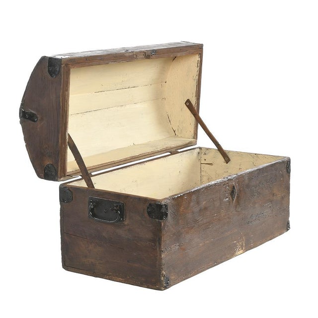 Wooden chest or transport trunk with metal reinforcements. This piece is designed in the style of the selected designer...