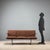 Vintage three-seater sofa featuring a minimalist design. The clean lines make it suitable for various settings, from a...