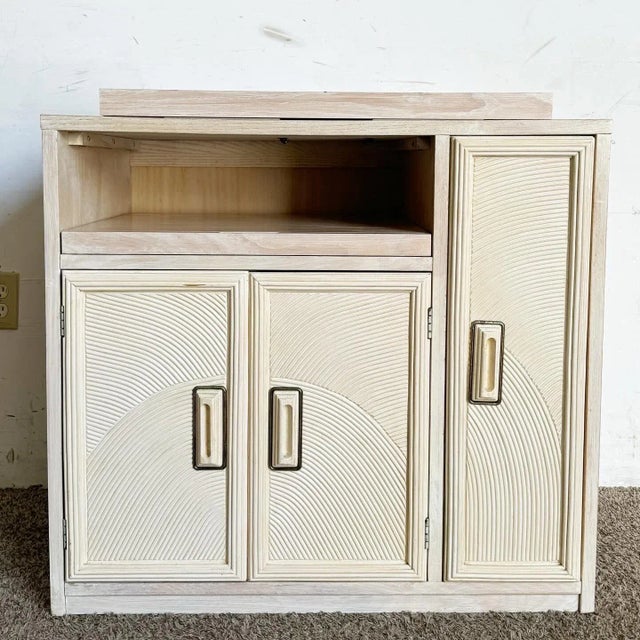 Elevate your entertaining space with this Boho chic Henry Link pencil reed cabinet/dry bar. Featuring a unique rotating...