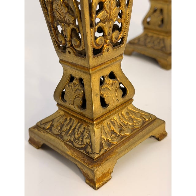 Pair of late 19th-century gilt candle holders featuring intricate openwork casting and classical acanthus-leaf decoration....