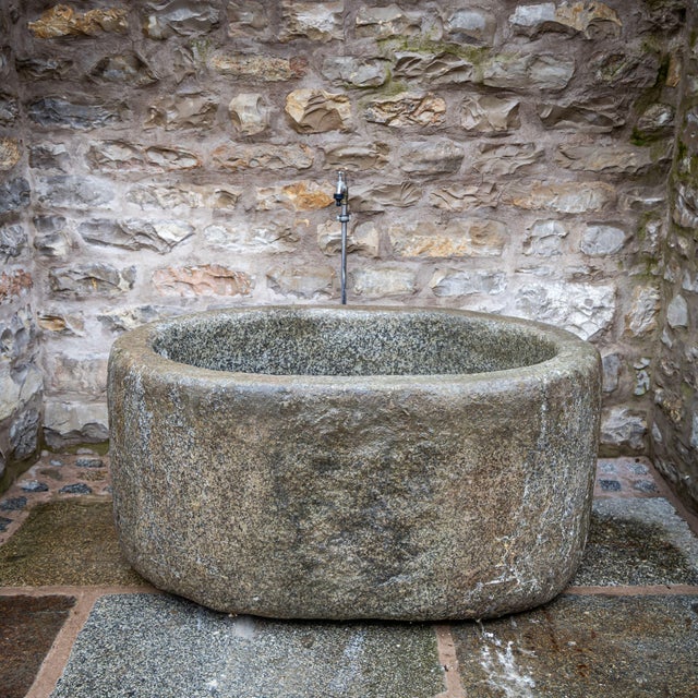 Large oval stone trough with smooth sides, carved from a single solid block of granite. Suitable as a decorative garden...