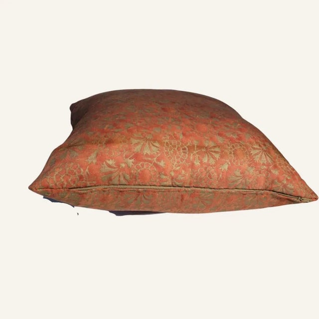 Fortuny silk pillow filled with down. In shades of salmon and olive with a floral/pinwheel pattern.