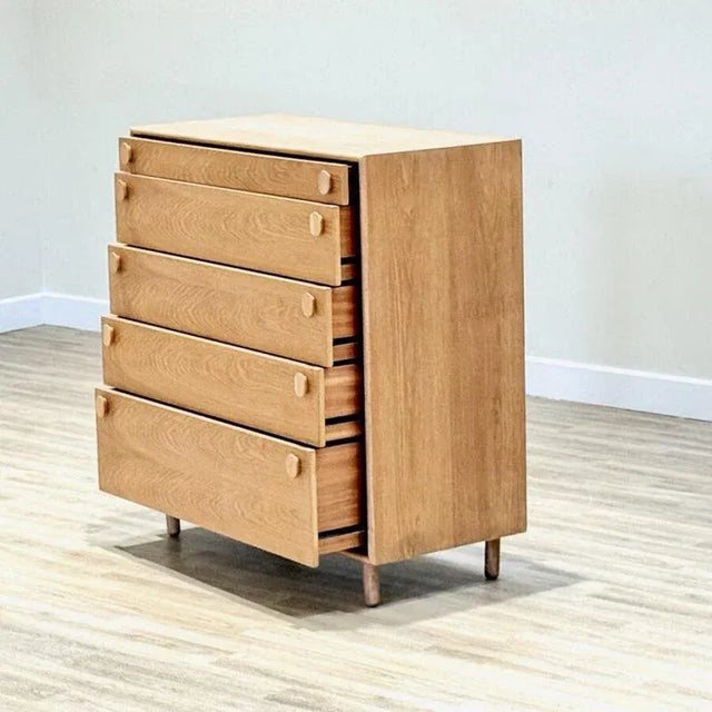 A beautiful handcrafted Meredew chest of drawers from the 1960s , made in solid oak with the brand’s signature oval solid...