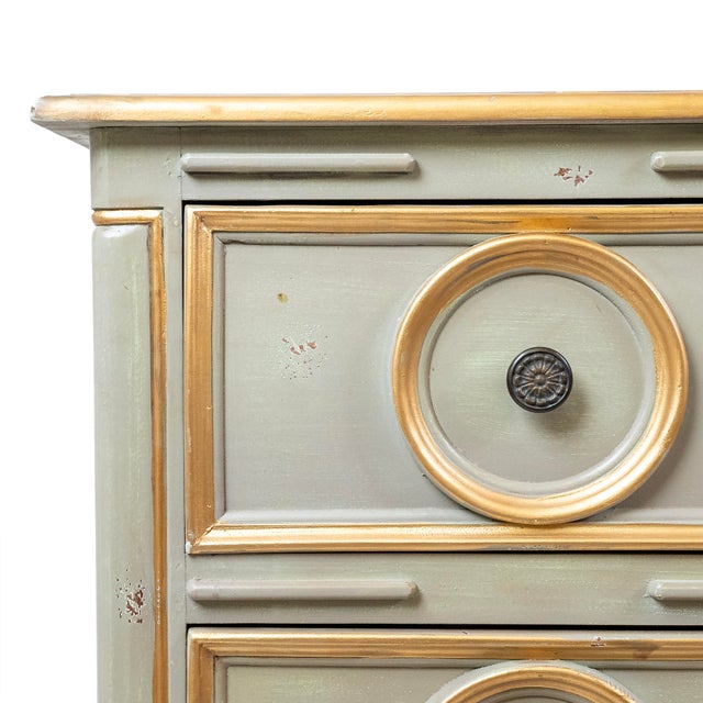 This handcrafted chest features a refined two-toned scrubbed gray painted red finish highlighted with elegant gold leaf...