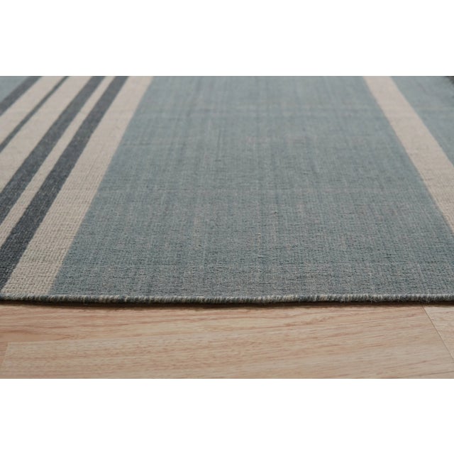 Opulent Majestic Blue Flatweave Wool Rug, Country of Origin: India. This exceptional piece redefines contemporary textile...