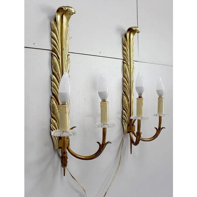 Beautiful Pair of lights in Two light arms in Golden Bronze, nicely decorated. Each has a high preciously elongate shaped...