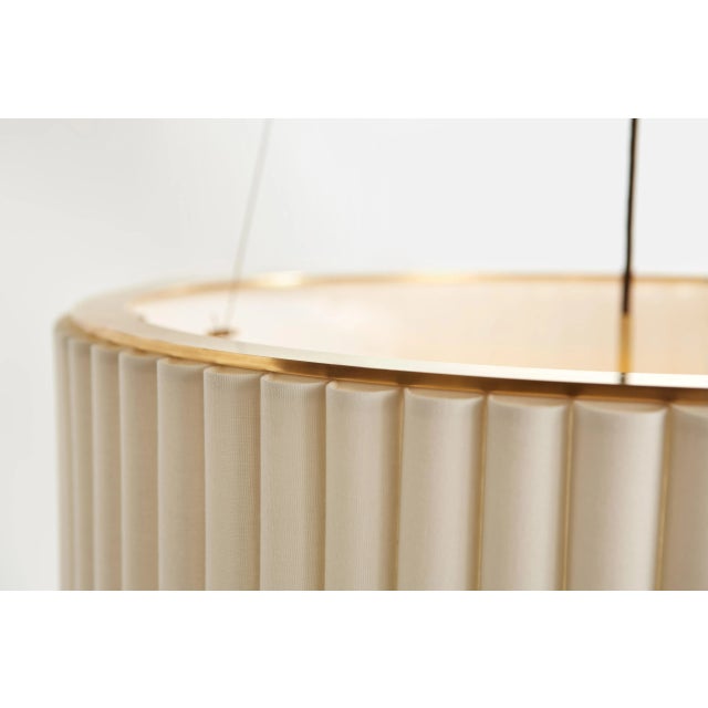 Palati Large Hanging Shade in Hand-Rubbed Antique Brass with Linen Shade Designer: Ian K. Fowler Fixture Height: 7.75"...