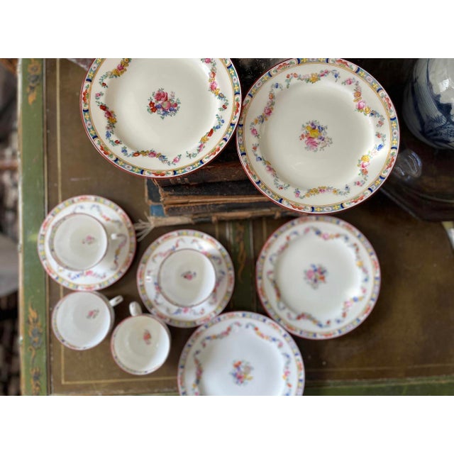 Gorgeous collection of 10 pieces of English fine china by Mintons. Presented on a crisp white, bouquets of blues, pink,...