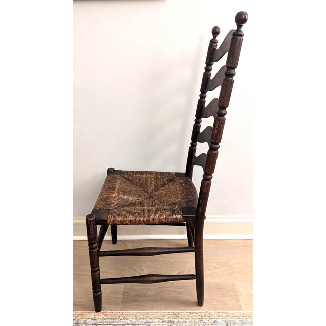 Great investment! This Heywood Wakefield antique ladder back chair has its original finish and original rush seat....