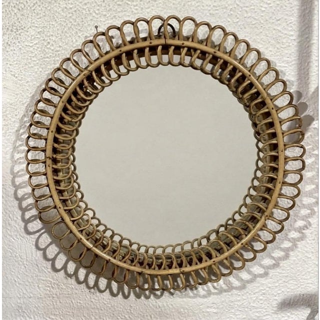 An elegant circular wall mirror, attributed to mid-century Italian design (inspired by the designs of Franco Albini and...
