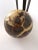 Lovely septarian nodule orb specimen. Comes with a tall patinated brass stand. Fluted legs are adorned with lion heads and...