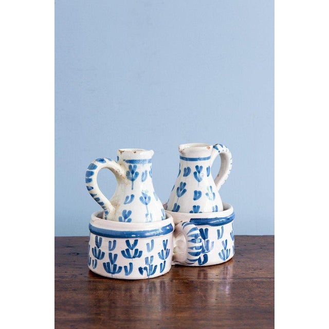 A charming French faience oil and vinegar set from Nevers, comprising two small jugs with their original double-...