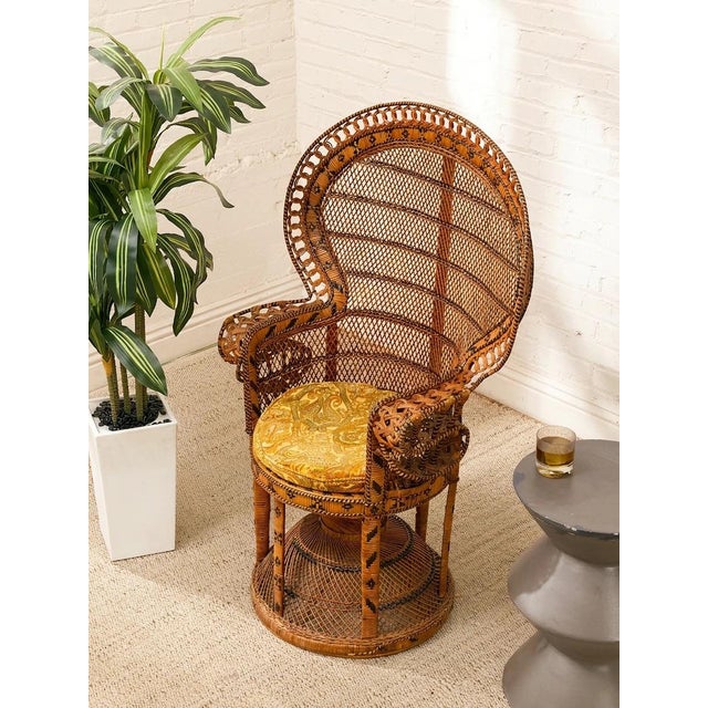 A wonderfully dramatic 1970s peacock chair crafted in richly toned woven wicker and rattan. Its oversized fan-shaped back...