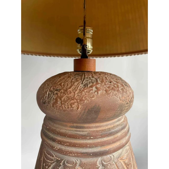 Vintage South American artisan lamp. Terra cotta with engraved imagery. Includes a starter shade.