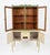 Charming vintage painted kitchen hutch featuring a two-piece look with a glass-front display cabinet above and enclosed...