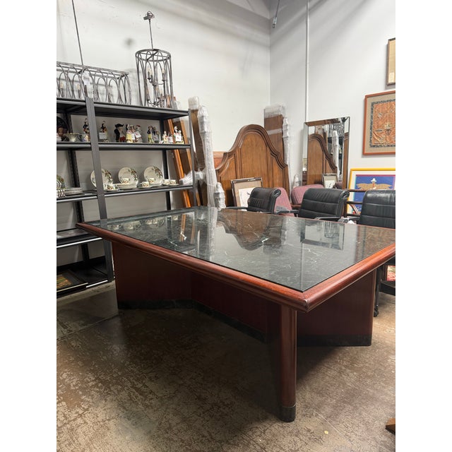 This Verde Marble Encased Mahogany Wood Conference Table puts a unique spin on a classic wooden table.
