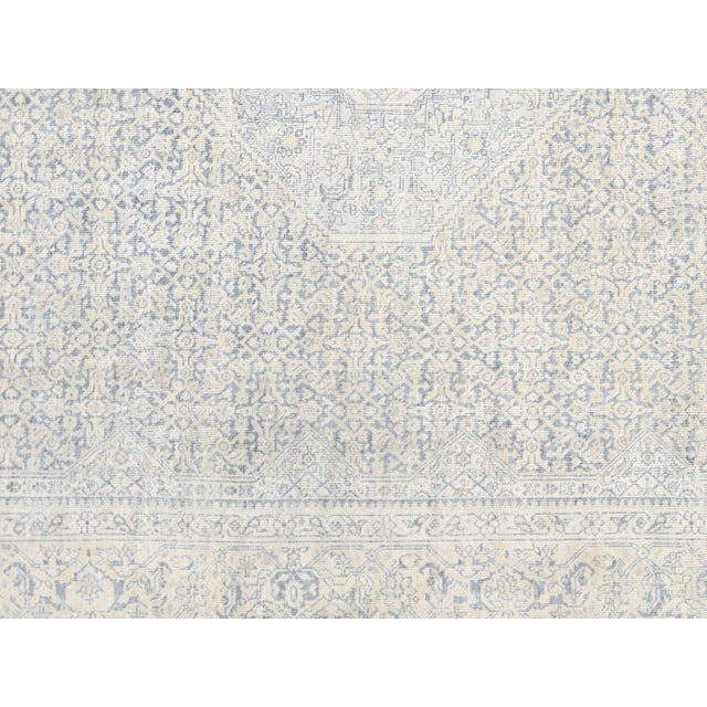 This lavish hand-knotted Persian Tabriz rug adds the perfect touch of elegance to any space. Its intricate design features...