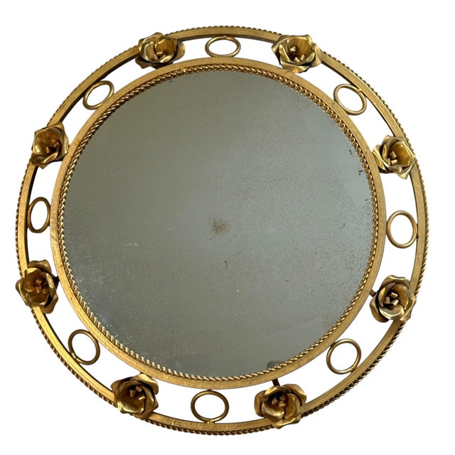 Magnificent round sunburst mirror from the 1960s. Italian craftsmanship. Decorated with roses. Can be wired for wall...