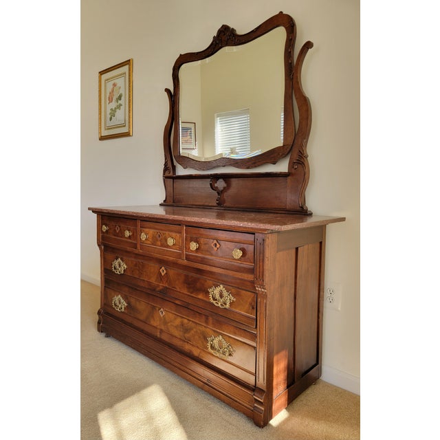 This exquisite example of Victorian Eastlake furniture features elaborate carvings and incised designs. The mirror frame...