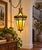 A dramatic vintage six-panel stained glass hanging swag lantern featuring an ornate Gothic and Mediterranean Revival-...