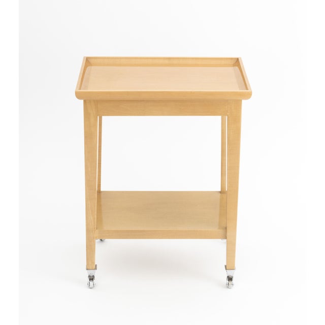 J. Robert Scott Lacquered Wood End Table, plaque label to underside, with two tiers above casters. 20" H x 15.5" W x 10.5"...