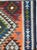 This Mid-20th century Persian flatweave kilim presents a bold, symmetrical composition centered on a series of stacked...