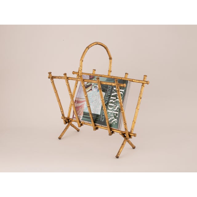 Rare Italian faux bamboo magazine rack from the 1970s, made from gilded Iron. The gently asymmetrical form appears to be...