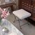 Beautiful iron stool with curved and looped base painted in a matte black finish inspired by French design. Rectangular...