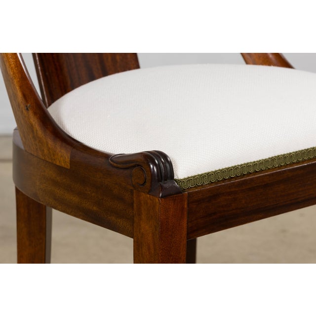 A refined set of six French Empire-style dining chairs dating to the early 20th century and sourced from Provence, France....